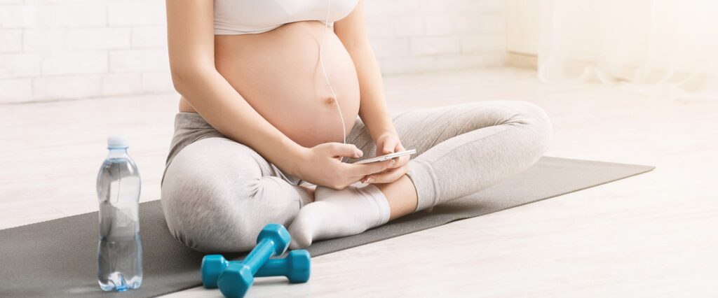 pregnant woman holding stomach