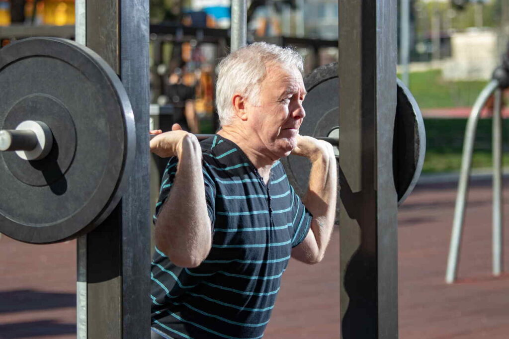 elderly man lifting weights