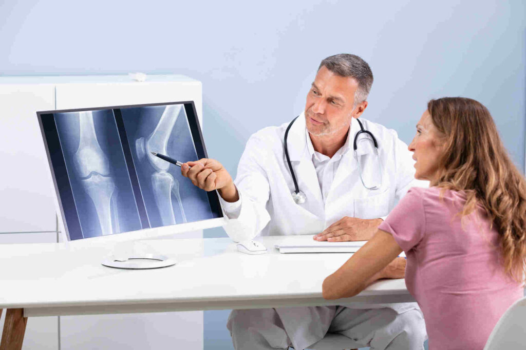 doctor showing knee x-ray to patient